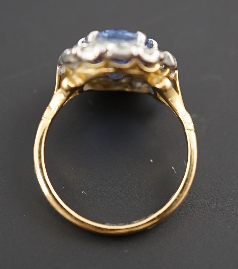 An 18ct gold, sapphire and diamond set oval cluster ring